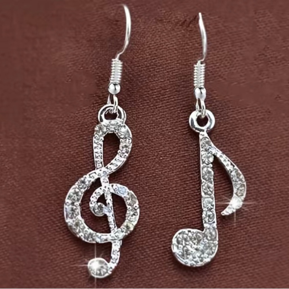 3/$24.   Asymmetrical, clef and note earrings in silver-tone for pierced ears